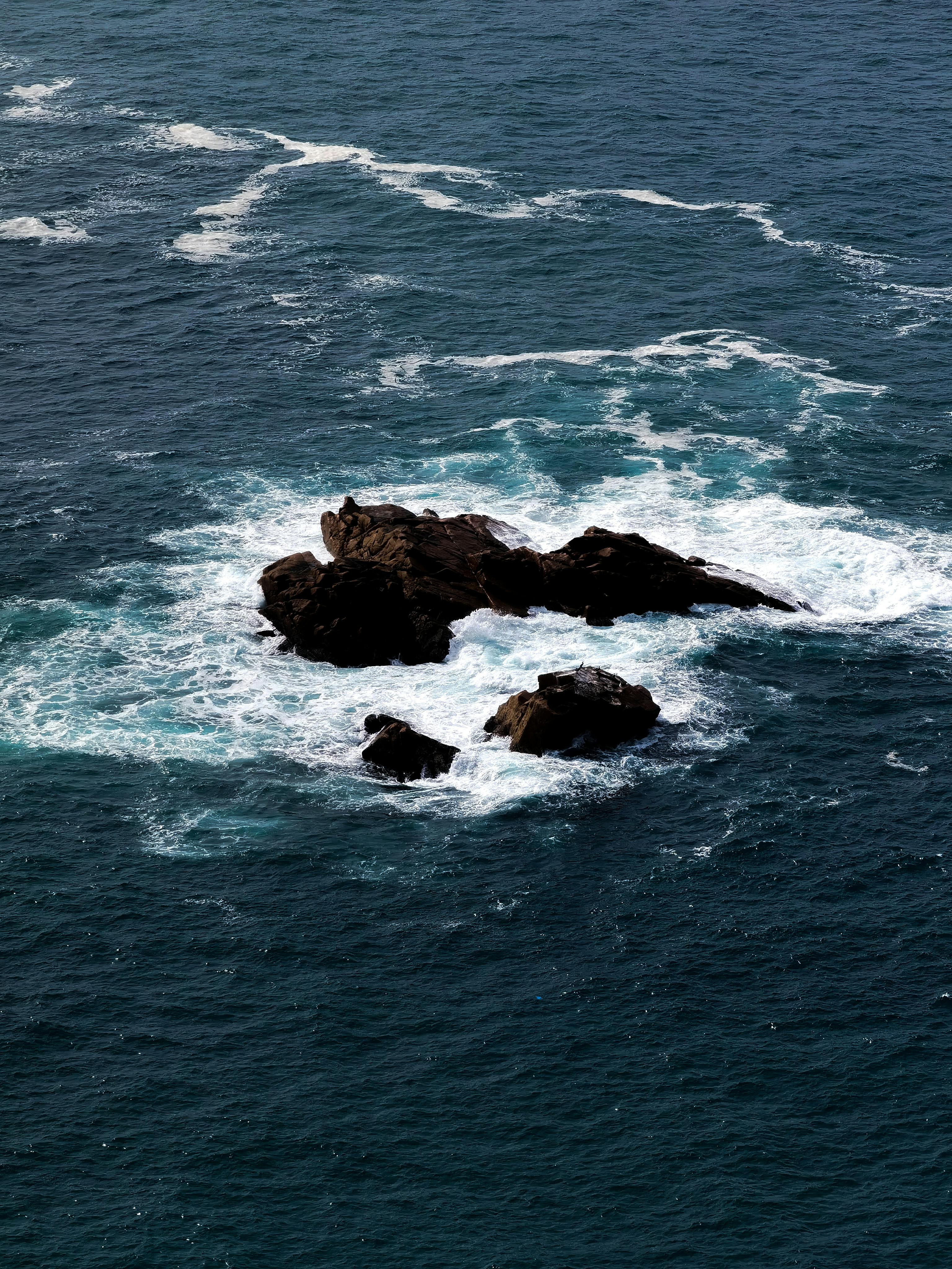 Rock Formation in the Middle of the Sea · Free Stock Photo