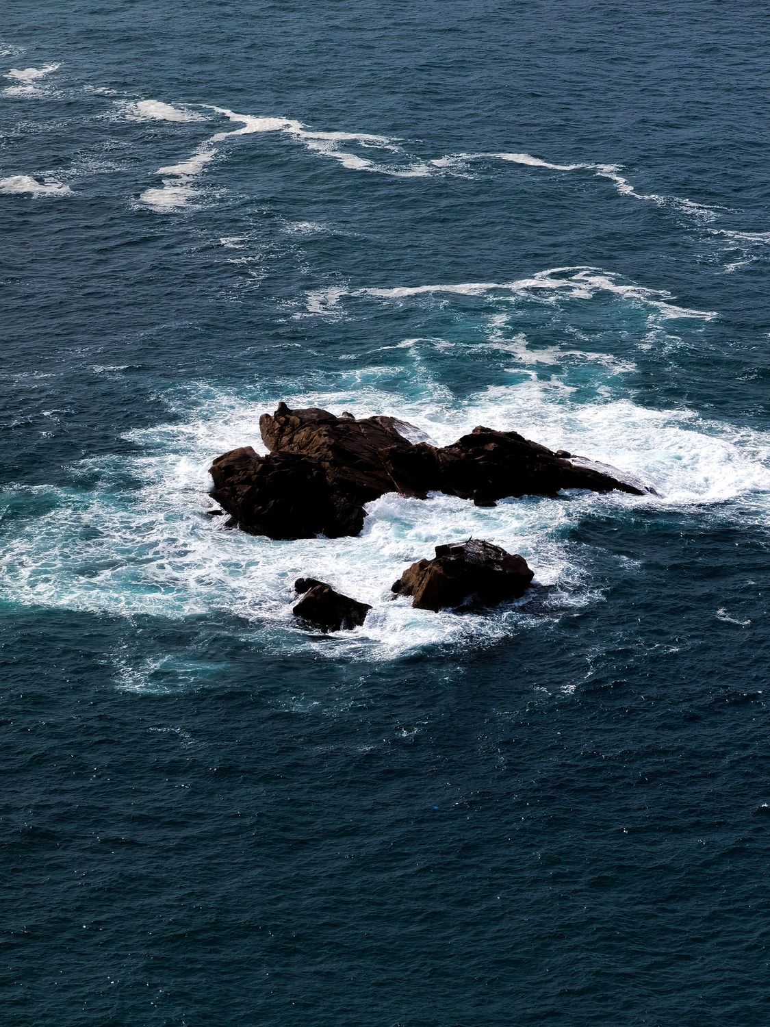 Rock Formation in the Middle of the Sea · Free Stock Photo