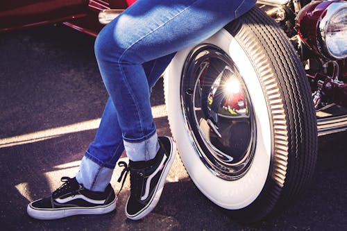 Person Sitting on Vehicle Wheel