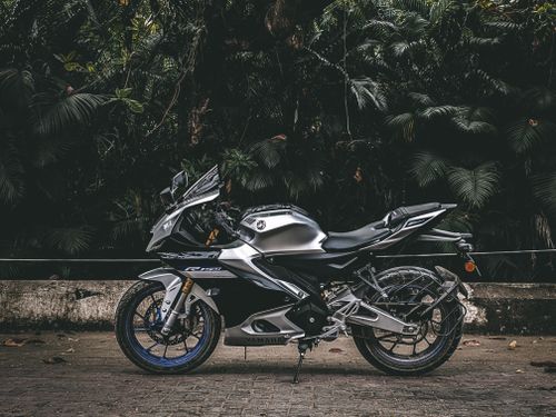 Free Side view of a stylish black Yamaha motorcycle parked outdoors in Chennai. Stock Photo
