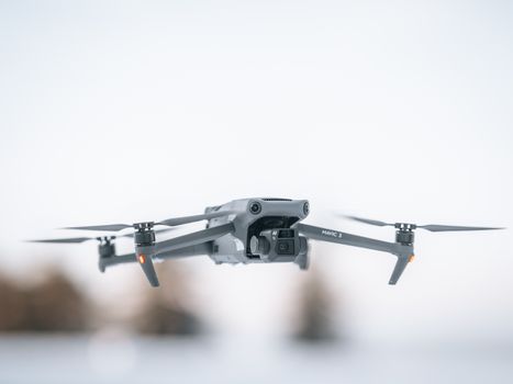 High-resolution image of a modern drone flying in the sky during daytime.