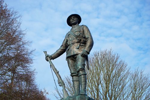 Free Bronze World War I soldier statue in England on a clear day. Stock Photo
