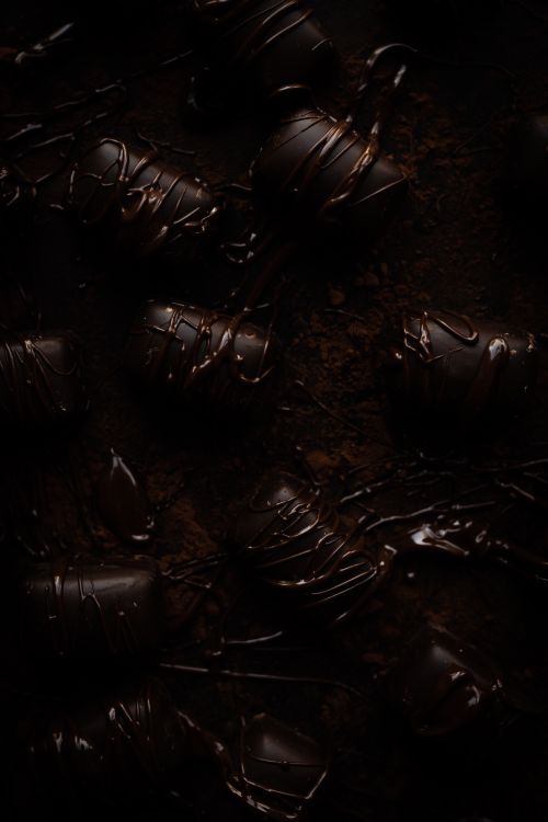 Free A selection of gourmet dark chocolates elegantly drizzled, ideal for food photography. Stock Photo