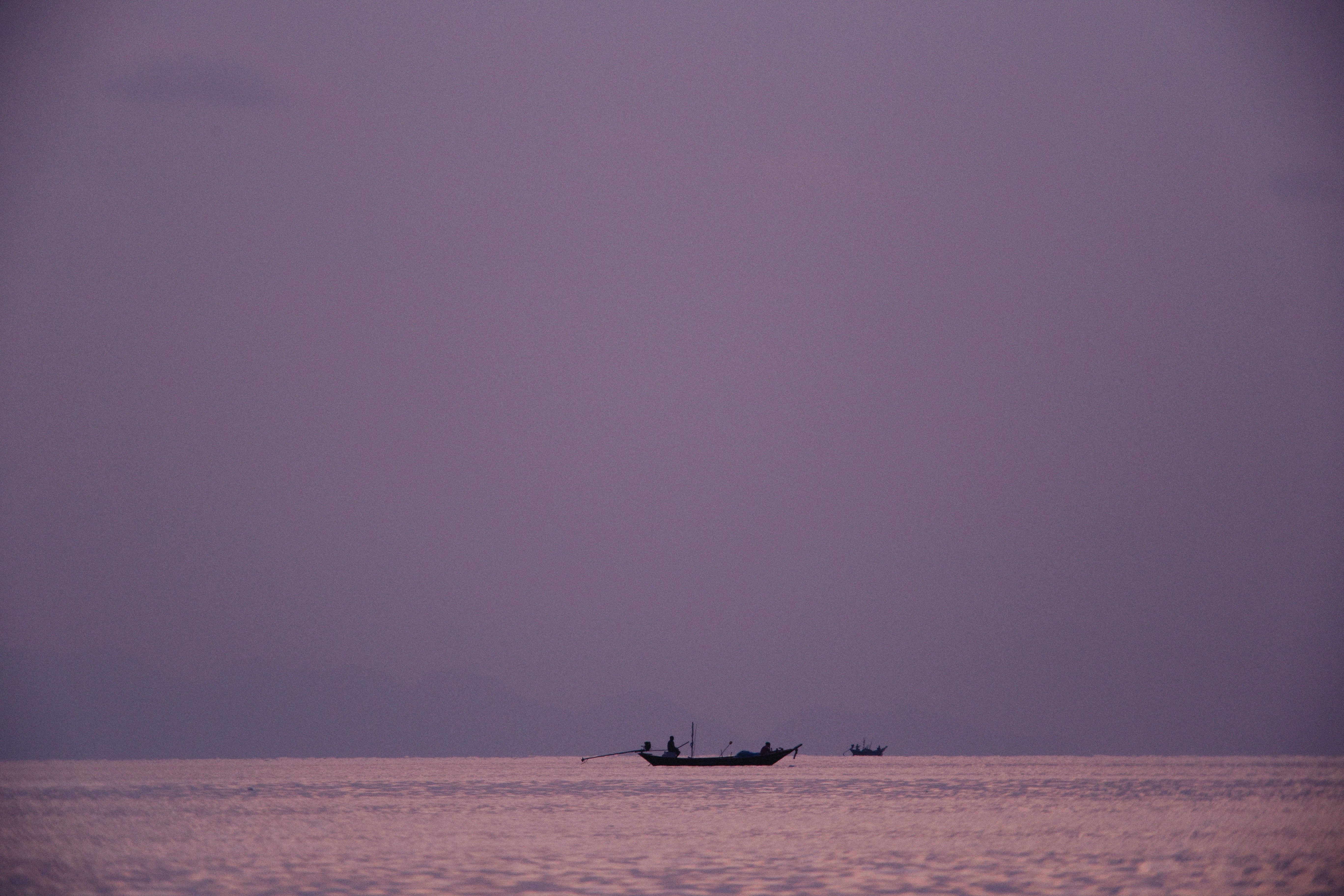 Silhouette of Boat on Body of Water · Free Stock Photo