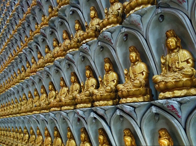 Golden Buddha Statues On Wall