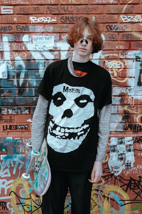 Teenage Boy Holding a Skateboard 