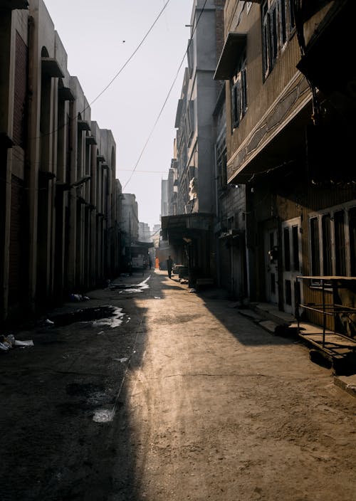 Narrow Dirt Road Between Buildings