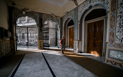 A Person Walking inside the Mosque