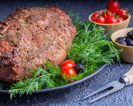 A delicious roast beef seasoned with herbs and garnished with cherry tomatoes, perfect for a gourmet meal.