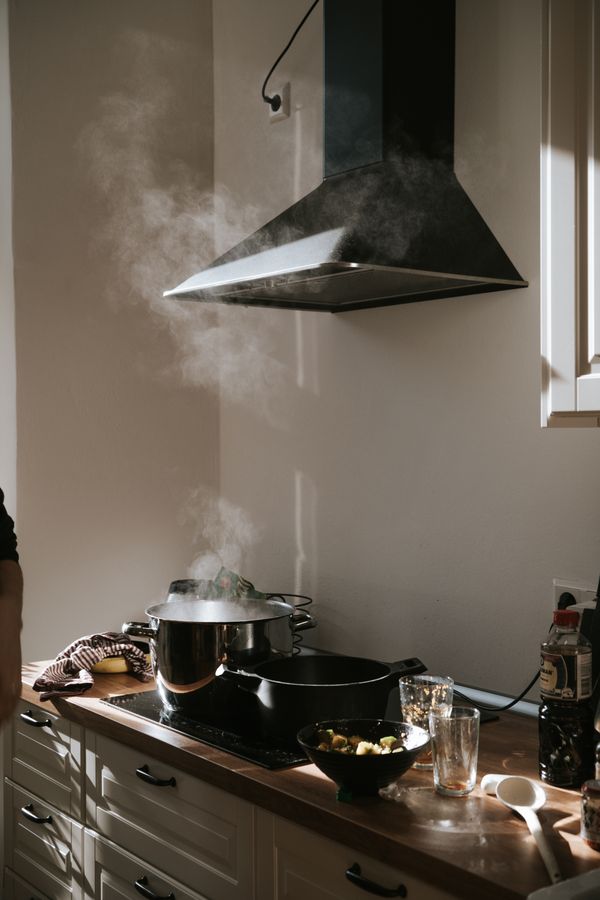 Greasy kitchen stove under hood before service