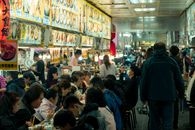 People Sitting on Chair in Front of Food Stalls
