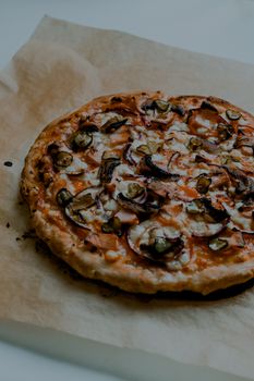 Savor a delicious homemade pizza topped with fresh mushrooms, cheese, and pickles.