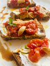 Brown Bread With Tomato and Green Vegetable on White Ceramic Plate