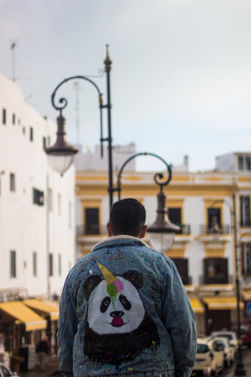 Back View of Man in Denim Jacket With Panda Paint 