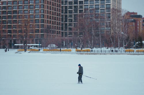 

A Man Skiing on a Snow Covered Field