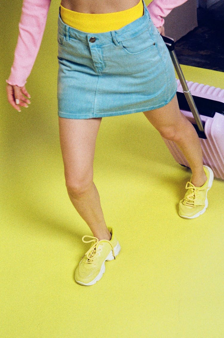 Woman In Colorful Clothes Carrying Pink Suitcase