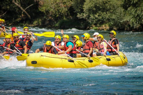 People in Yellow Inflatable Raft on Water