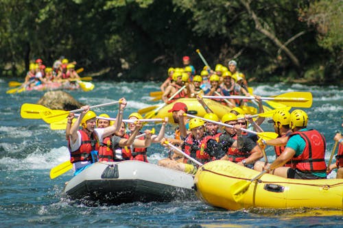 People Riding on Inflatable Boats on Body of Water