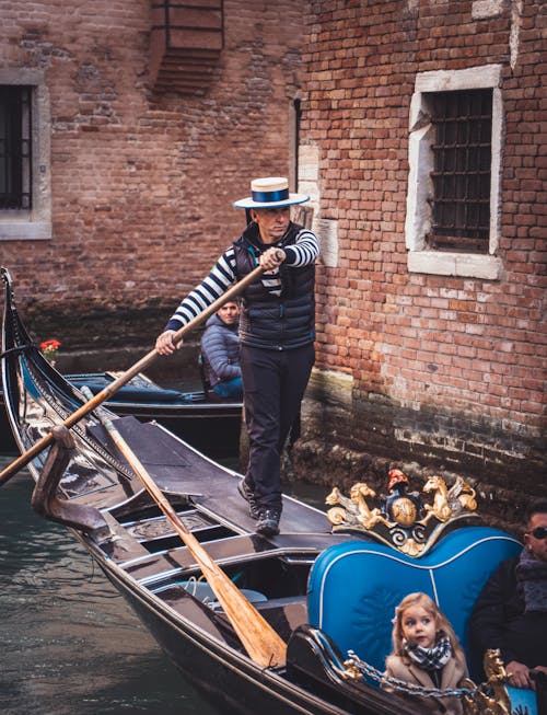 A Gondolier Controlling the Gondola on a Canal