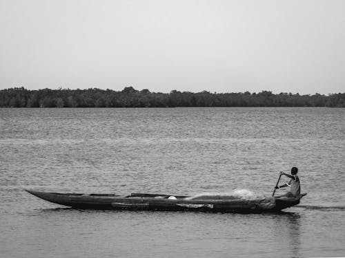 Free Grayscale Photo of Person Riding on Boat  Stock Photo