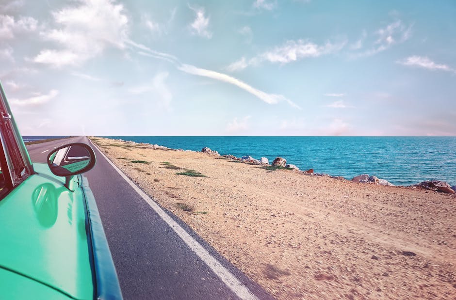 Green Car Near Seashore With Blue Ocean