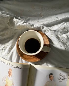 Relaxing morning with coffee and reading on an embroidered bedspread in Manila.