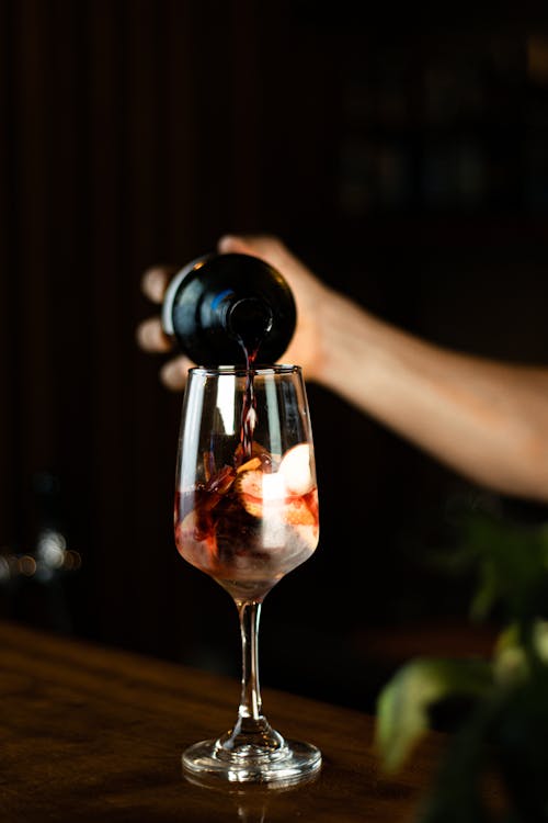 Free A Person Pouring Wine on a Glass Stock Photo