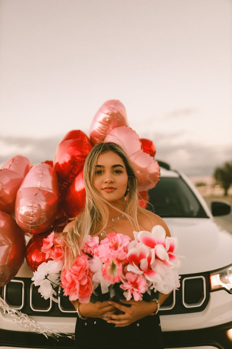 Woman With Flowers And Car With Balloons Behind