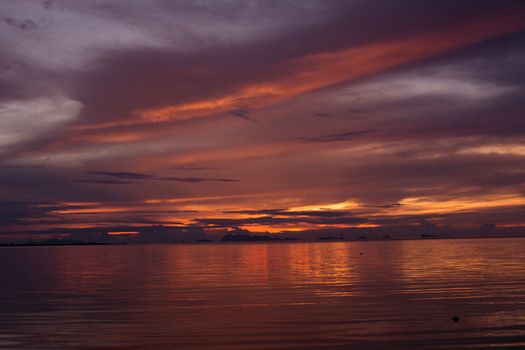 Captivating sunset scenery reflecting on a calm ocean, capturing the golden hour's majestic hues.