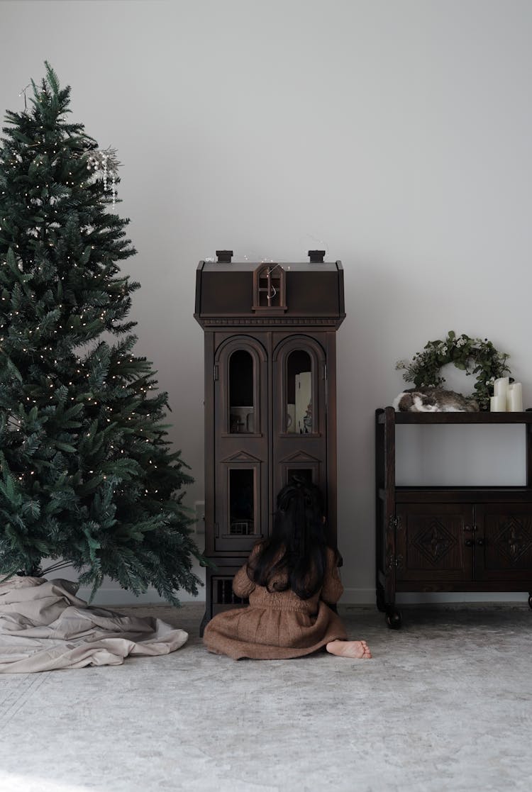 Child Sitting By Toy Castle On Carpet