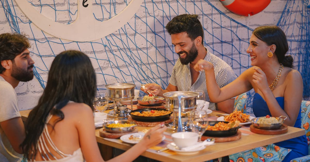 People Laughing At A Dinner Table With One Person Looking Embarrassed