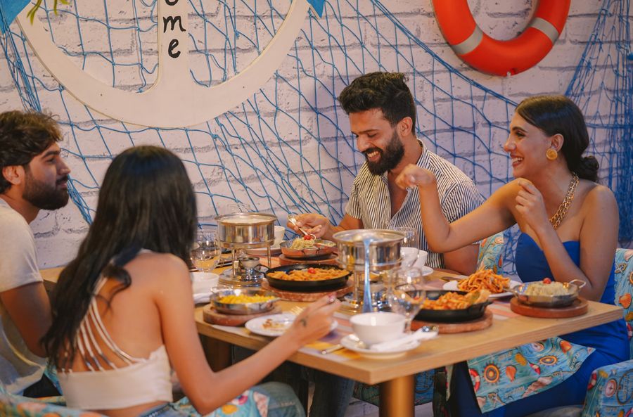 Four friends sharing dinner at a restaurant table