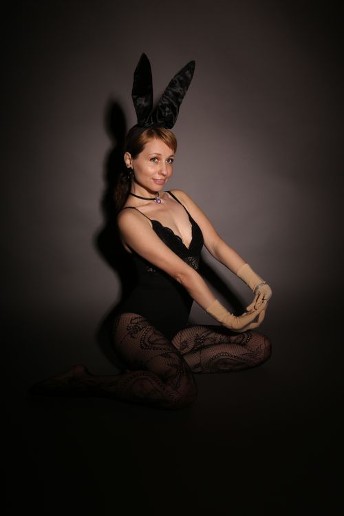 Free Portrait of a woman in a stylish costume with bunny ears, captured in a studio setting. Stock Photo
