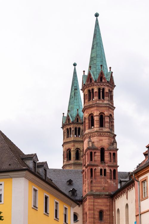 Free Vertical shot of Würzburg Cathedral's distinctive twin towers amidst surrounding architecture. Stock Photo