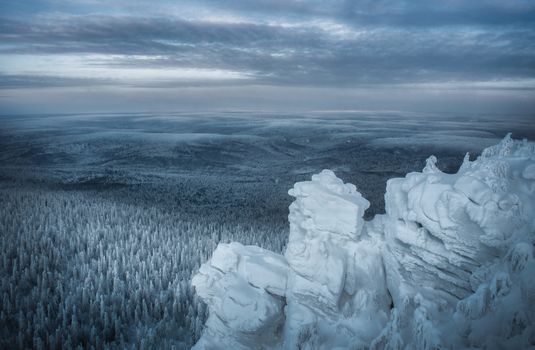 A stunning winter landscape of snow-covered mountains and forest in Perm Krai, Russia.