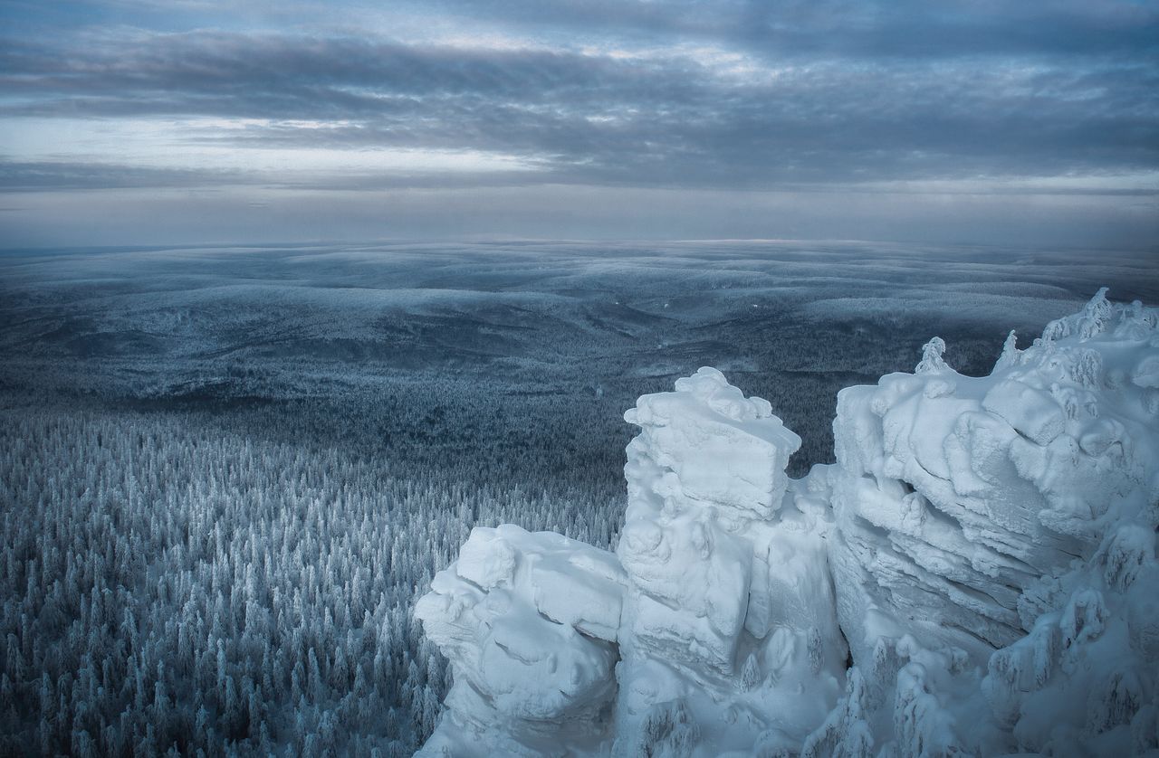 a stunning winter landscape of snow covered mountains and forest in pe