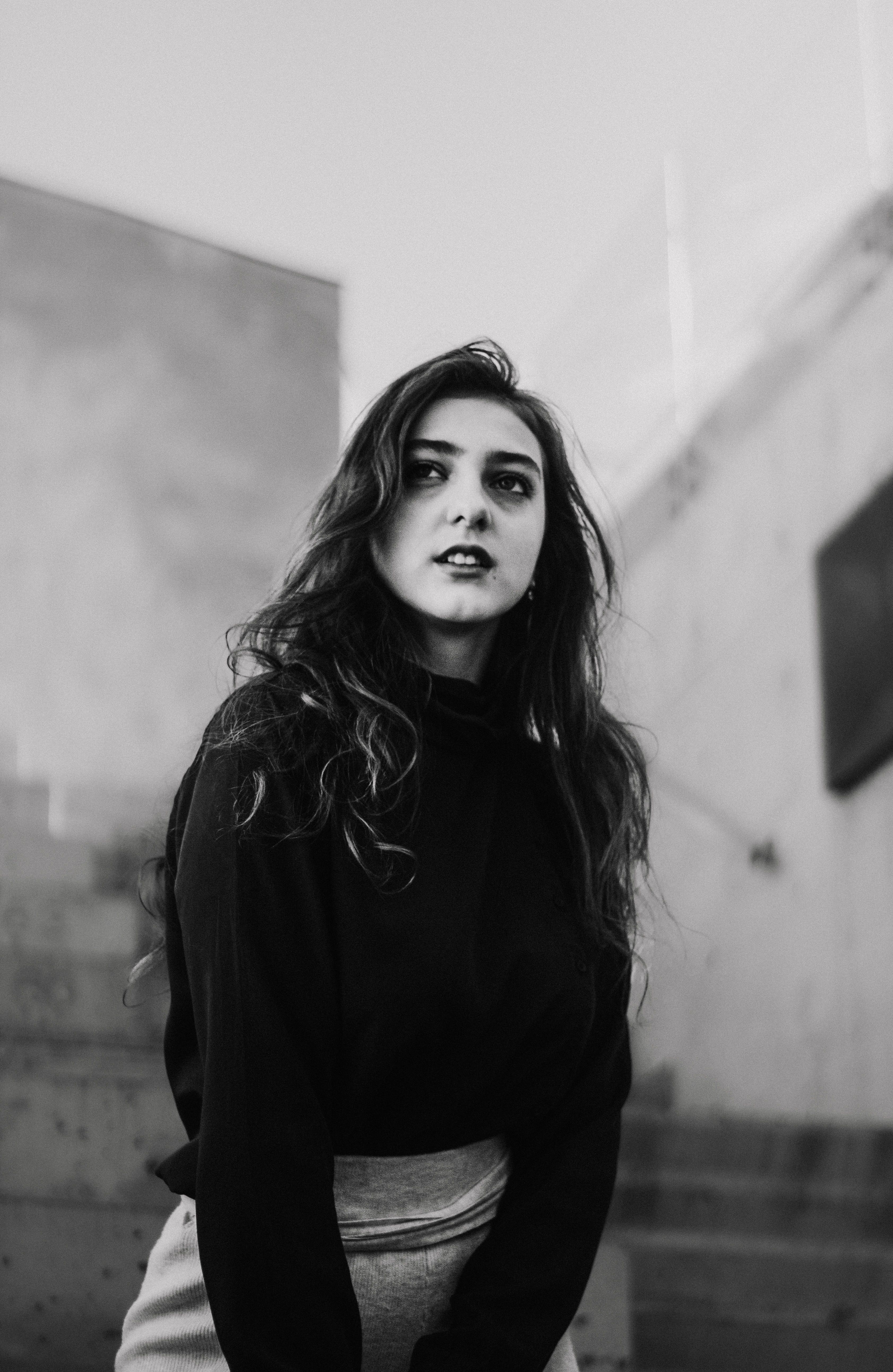 Monochrome portrait of an adult woman in a black sweater, outdoors in Chișinău, Moldova.