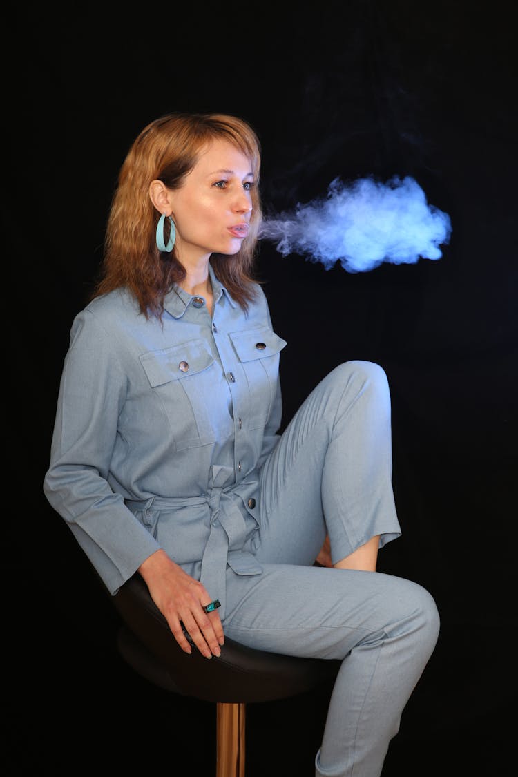 A Woman Blowing Out Smoke