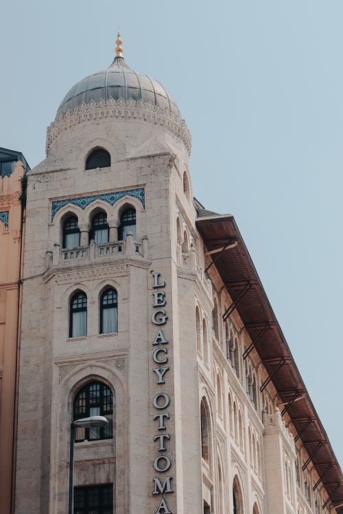 Free Low angle view of the Legacy Ottoman building with domed architecture under a clear sky. Stock Photo