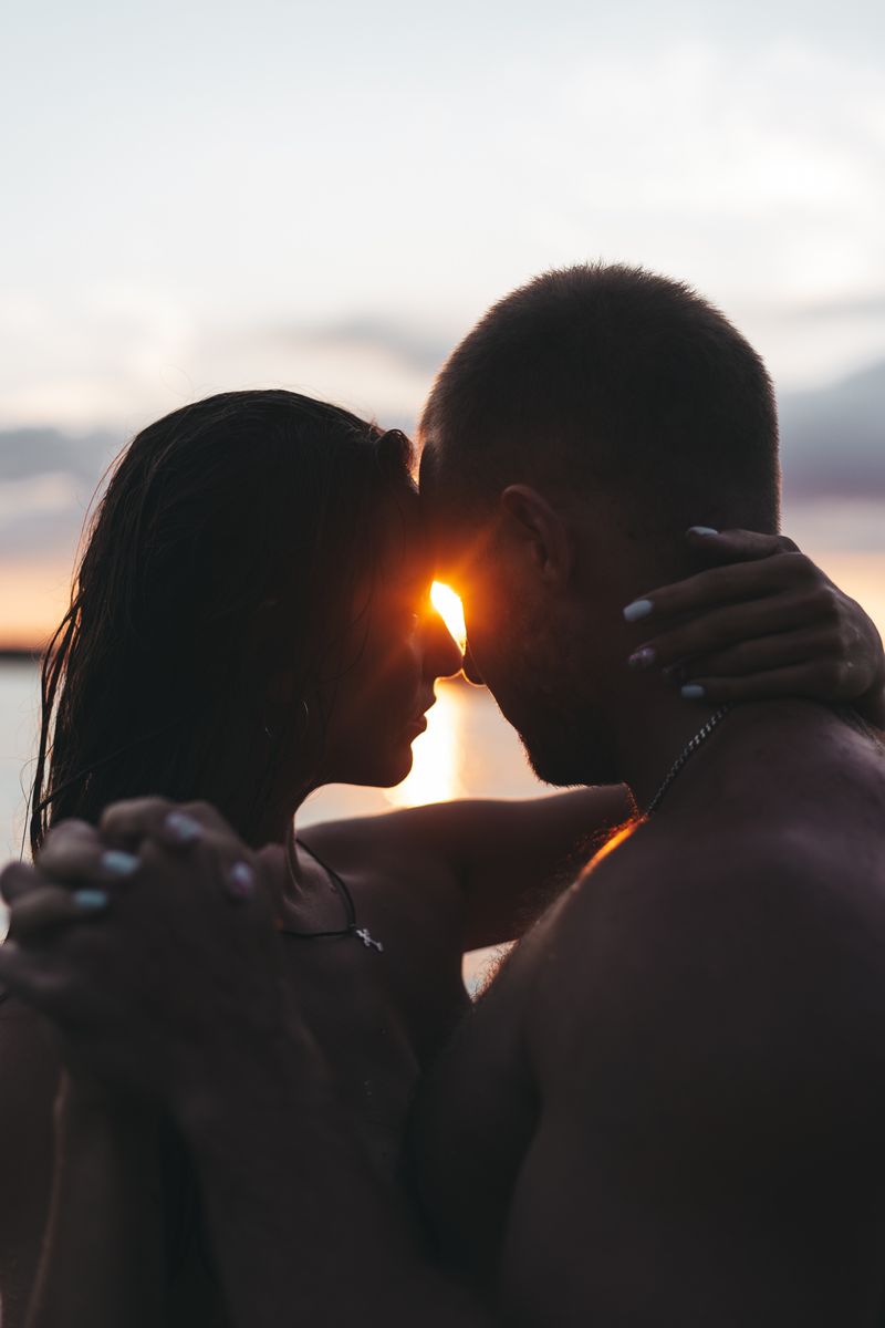 Couple embracing tenderly at sunset, trust rebuilt