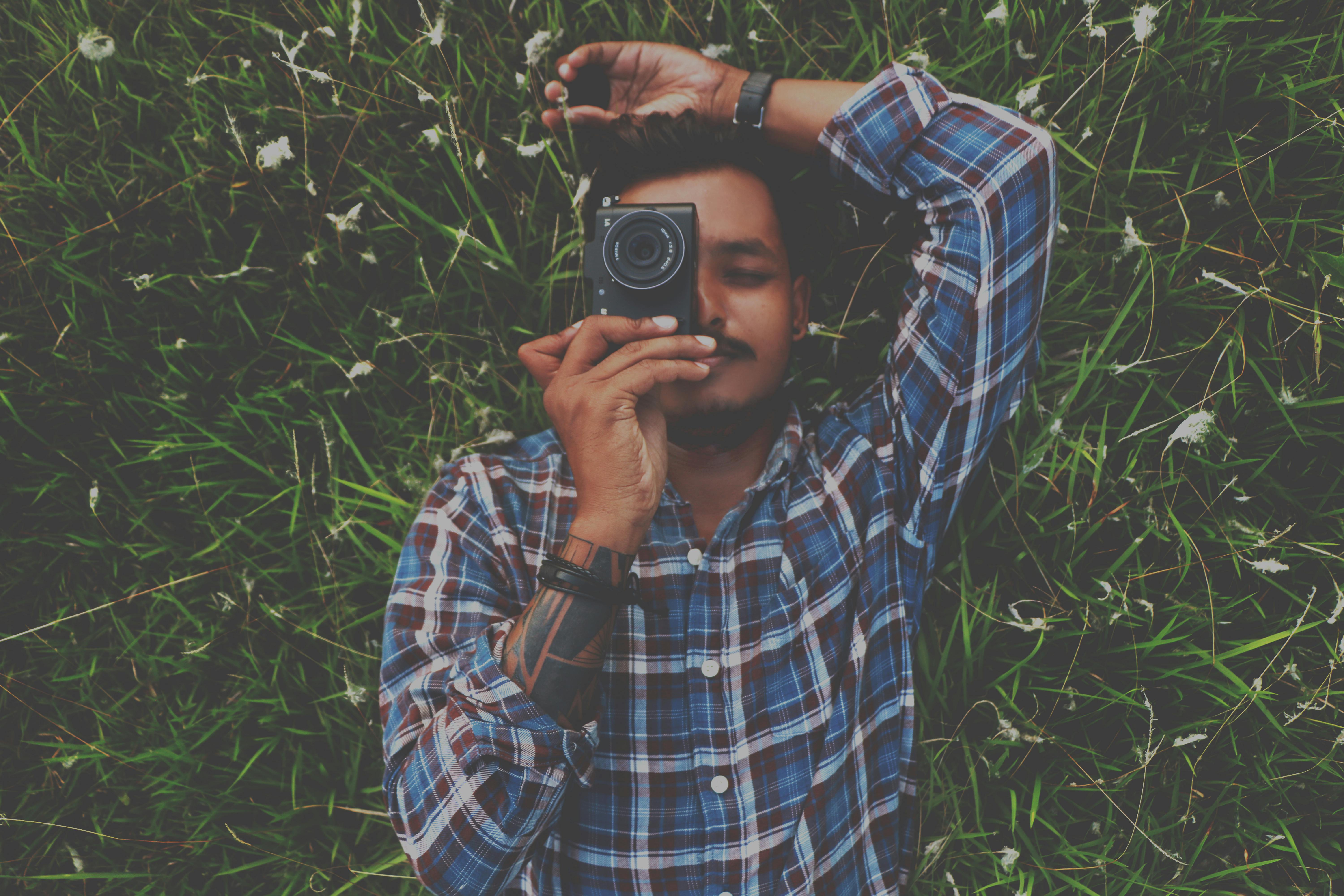 We need to change your pose Young African man holding retro styled camera  and looking at camera while standing against grey background 13556452 Stock  Photo at Vecteezy