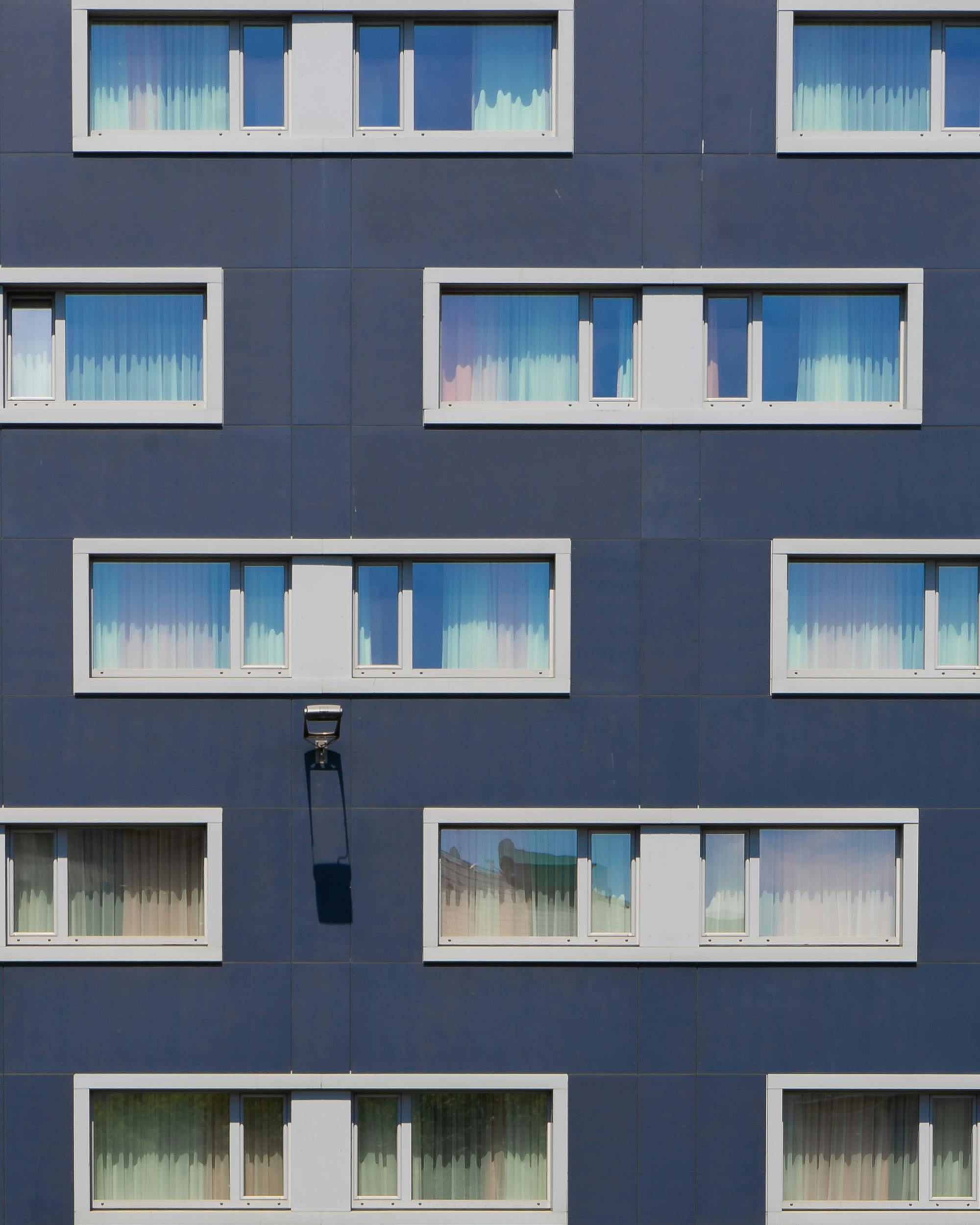Blue Painted Building With White Framed Windows · Free Stock Photo
