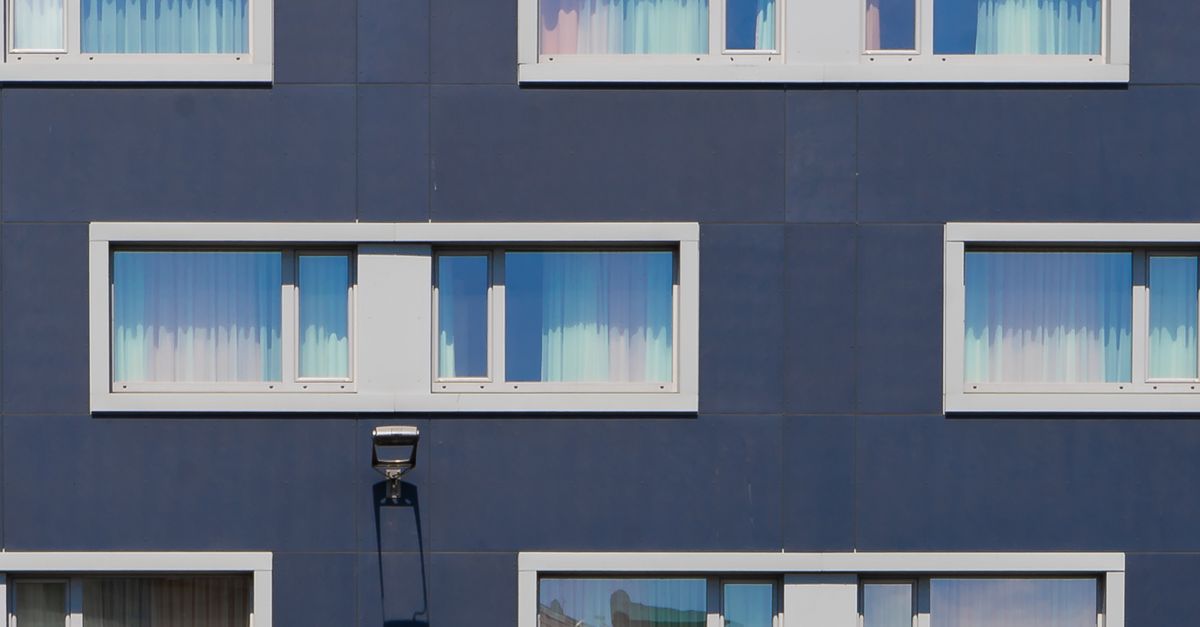 Blue Painted Building With White Framed Windows · Free Stock Photo