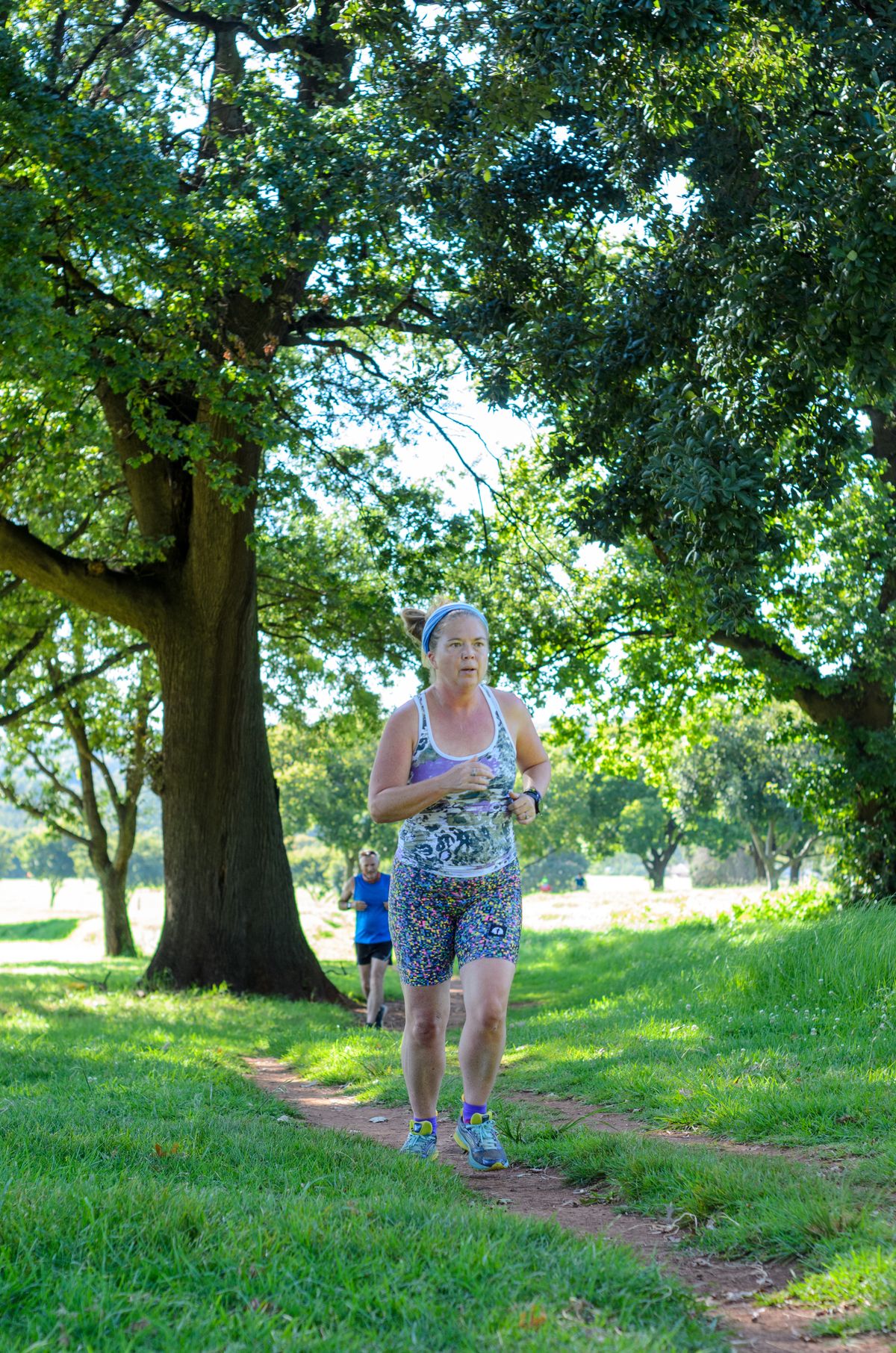 Woman running outdoors in a performance tank top