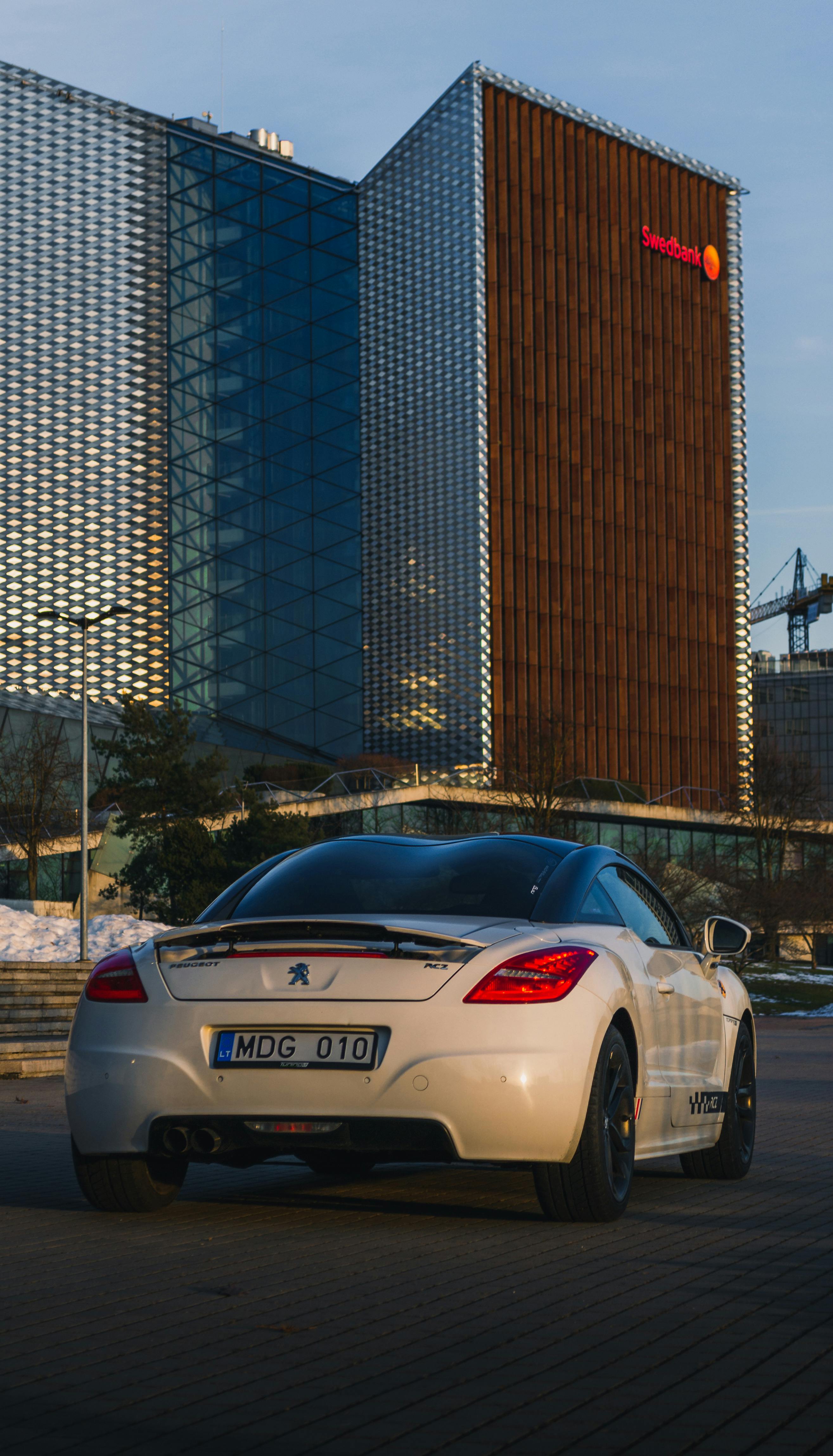 A White Peugeot RCZ Parked near a Building · Free Stock Photo A White Peugeot RCZ Parked near a Building · Free Stock Photo