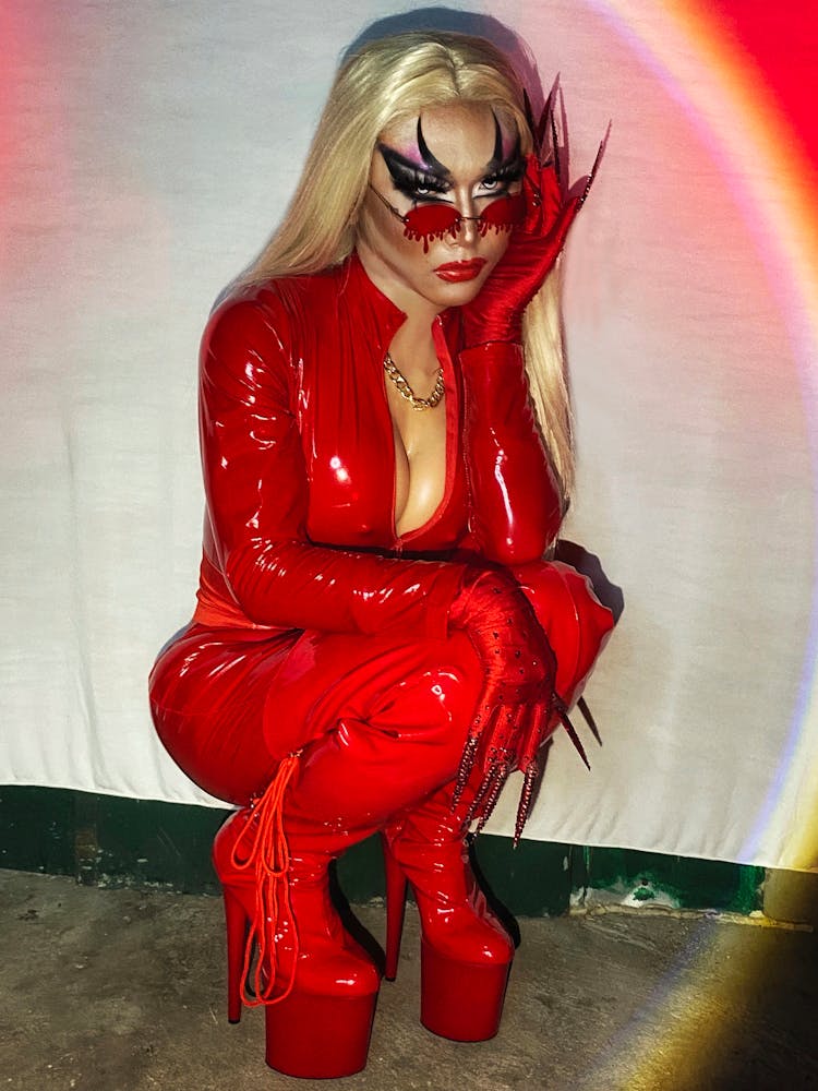 A Woman In Red Leather Jumpsuit