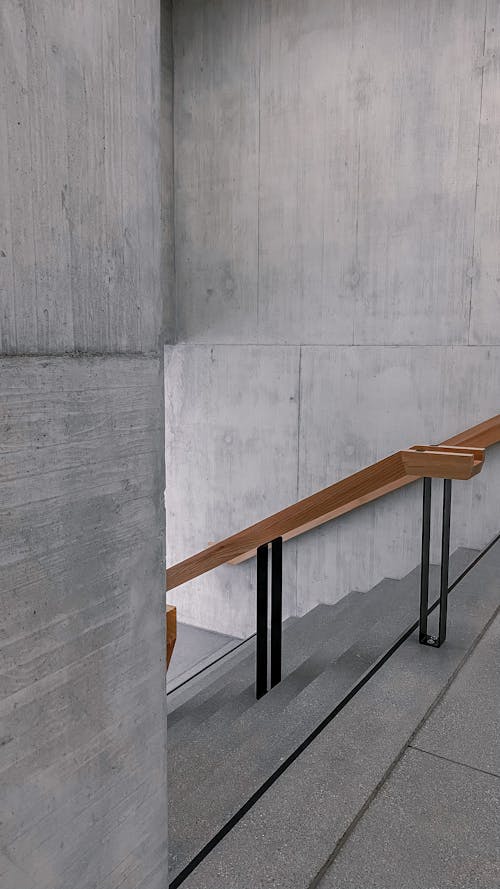 Brown Wooden Hand Rail on Concrete Stairs Near Wall