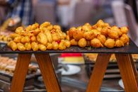 Tantalizing close-up of golden-brown fried fritters on display, showcasing Bangladesh's rich culinary tradition.