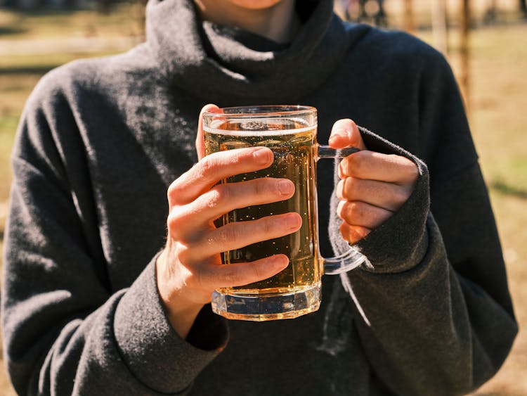 Person Holding A Beer Mug