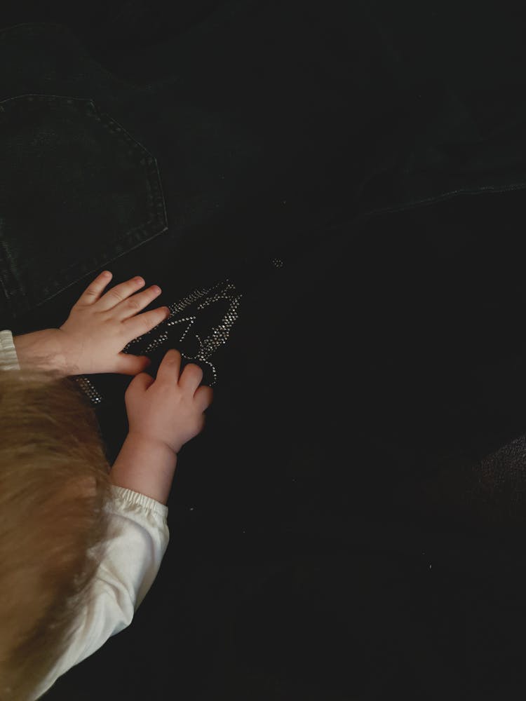 Baby Girl Touching Black Fabric